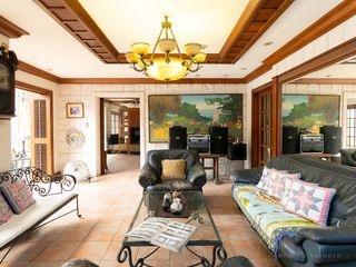A residential compound with 2 homes, 2 gates, 4 car garage. Designed for 2 family dwellings.